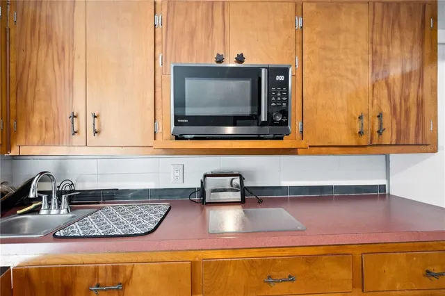 an aerial view of a house with a yard and lake view