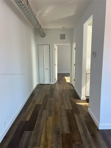 a view of a room with wooden floor