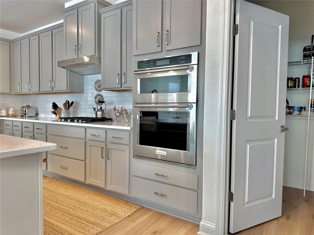 36 Signet Circle Flagler Beach, FL 32136 - Photo 13 of 45 a kitchen with white cabinets and stainless steel appliances