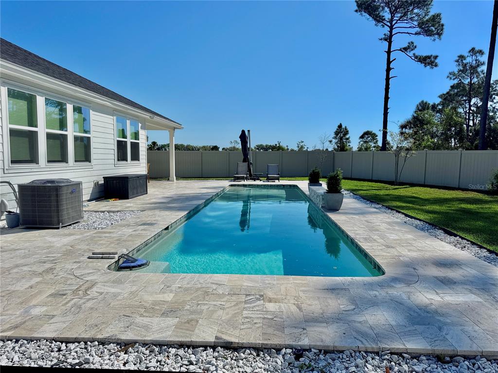 36 Signet Circle Flagler Beach, FL 32136 - Photo 19 of 45 a view of a backyard with couches plants and wooden fence