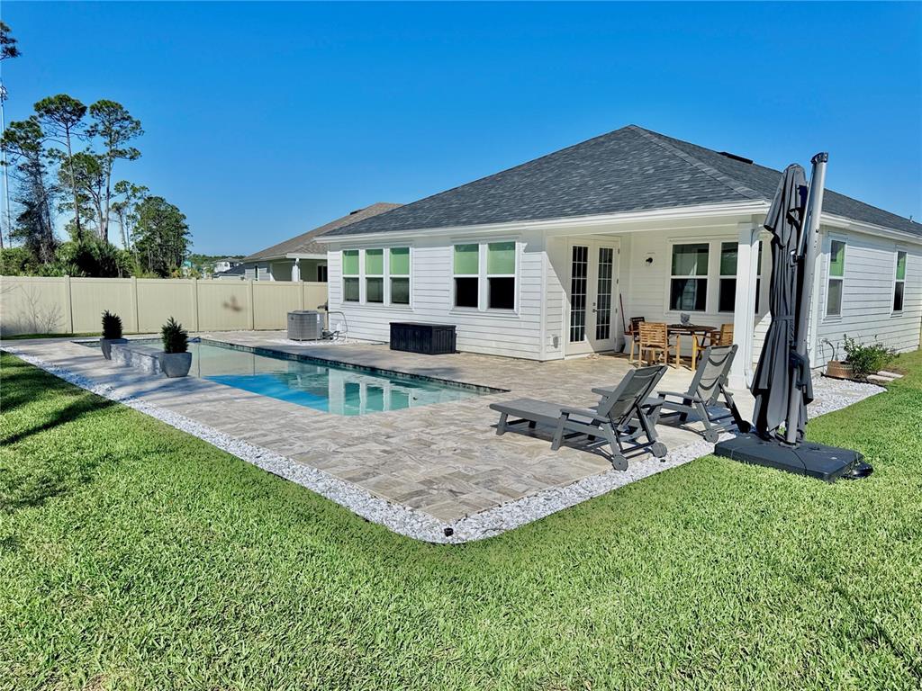 36 Signet Circle Flagler Beach, FL 32136 - Photo 2 of 45 a view of a house with backyard sitting area and garden