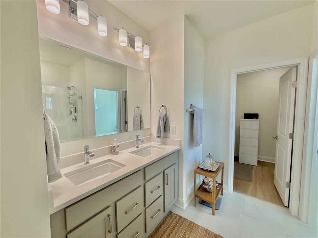 36 Signet Circle Flagler Beach, FL 32136 - Photo 26 of 45 a en suite bathroom with a double vanity sink a mirror and a shower