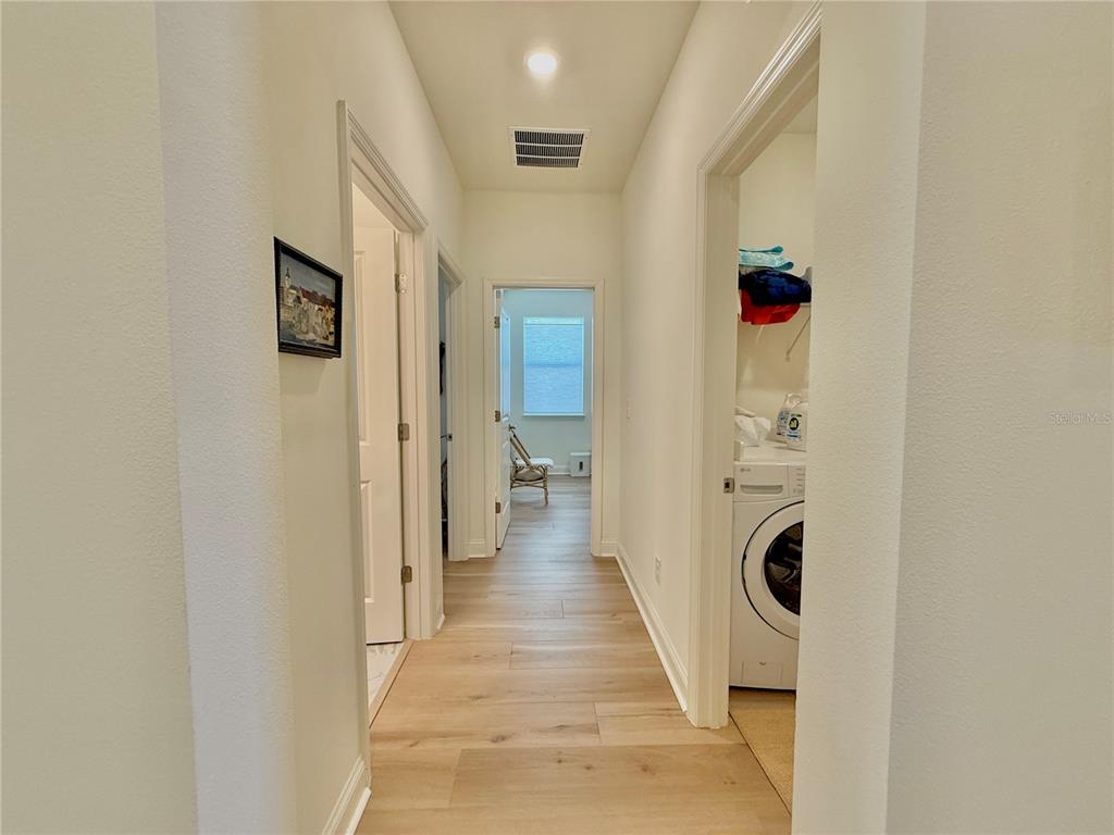36 Signet Circle Flagler Beach, FL 32136 - Photo 31 of 45 a view of a hallway with wooden floor and a bathroom