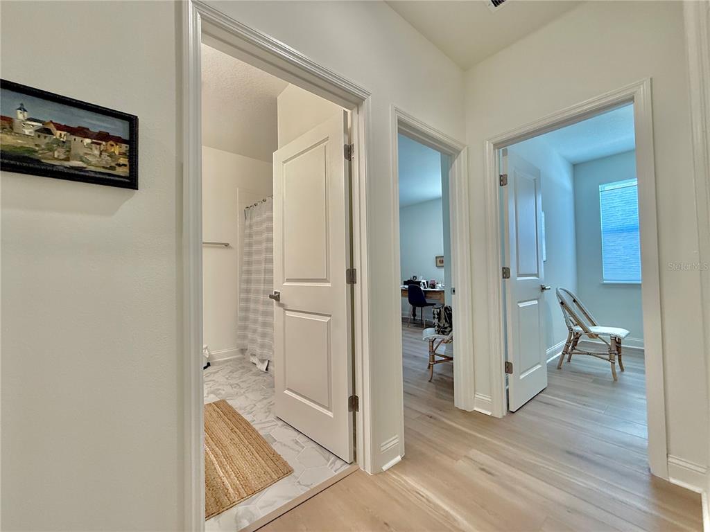 36 Signet Circle Flagler Beach, FL 32136 - Photo 33 of 45 a view of a hallway with wooden floor and a living room