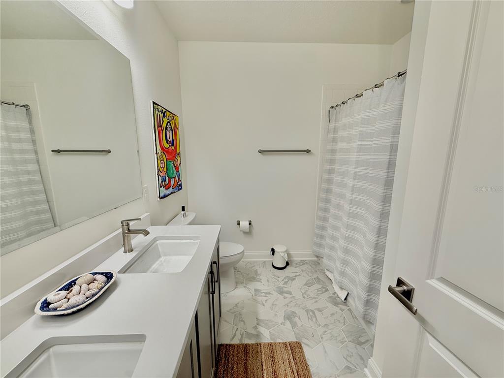 36 Signet Circle Flagler Beach, FL 32136 - Photo 34 of 45 a bathroom with a granite countertop sink a mirror and shower