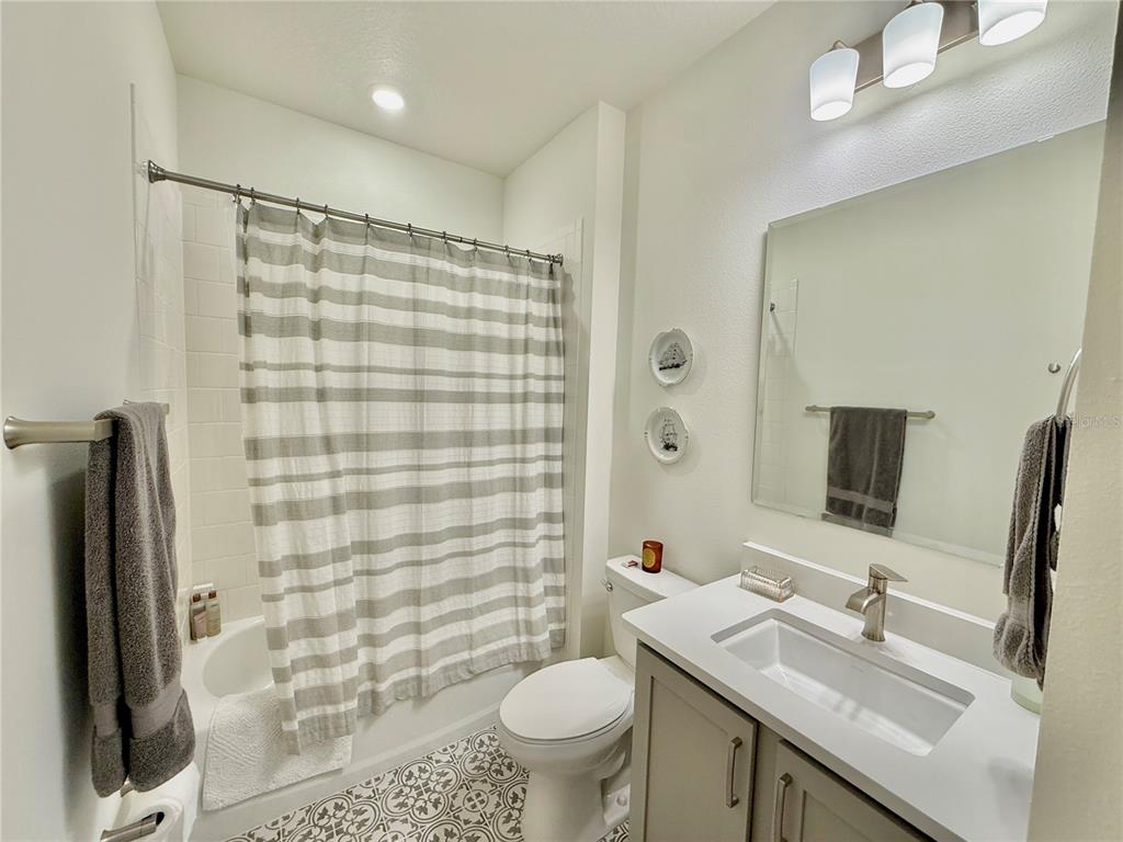 36 Signet Circle Flagler Beach, FL 32136 - Photo 41 of 45 a bathroom with a sink a toilet a mirror and shower curtain