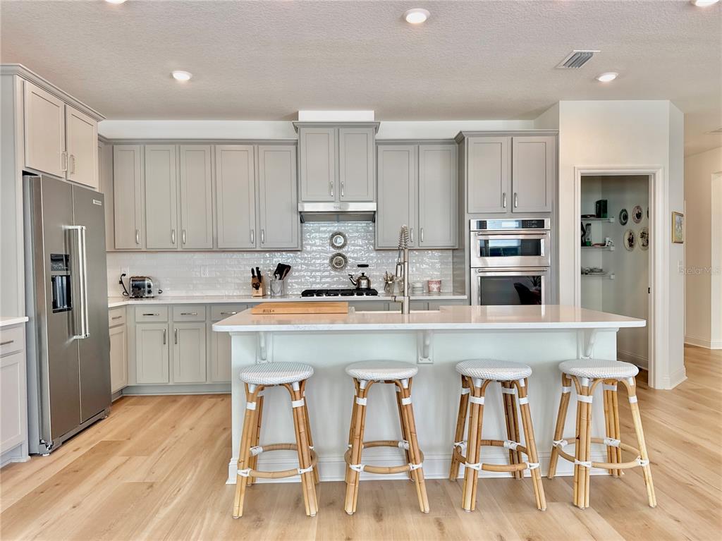 36 Signet Circle Flagler Beach, FL 32136 - Photo 10 of 45 a kitchen with stainless steel appliances granite countertop a table chairs refrigerator and sink