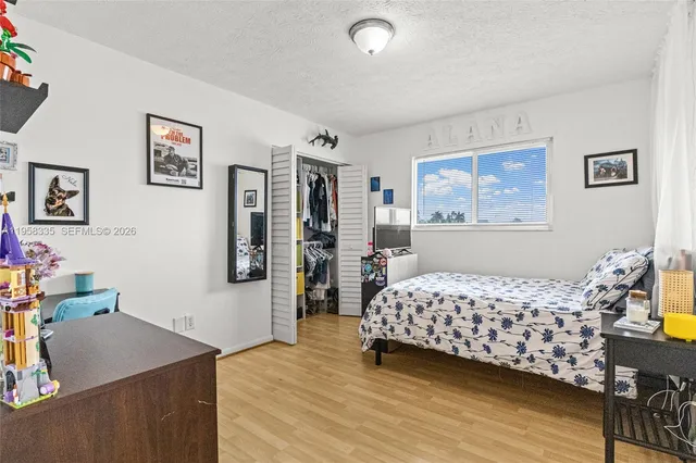 a spacious bedroom with a bed and a book shelf