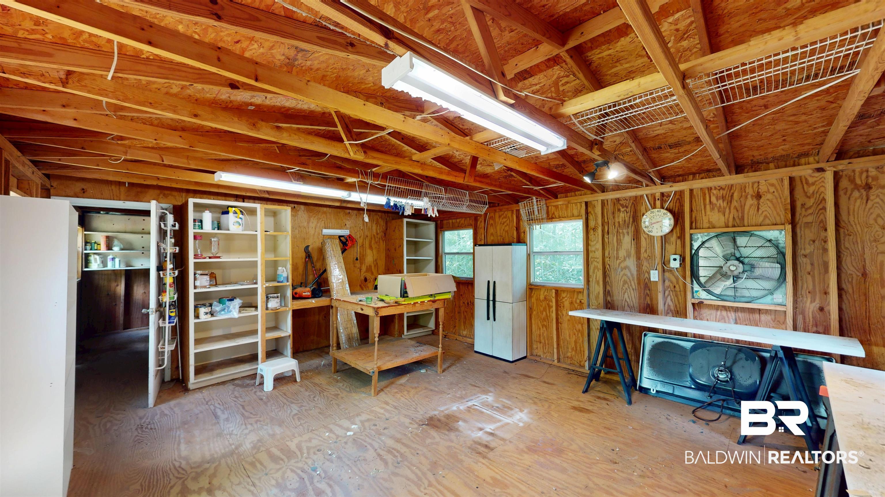 1075 Zurich Street Mobile, AL 36608 - Photo 9 of 35 Below grade area with freestanding refrigerator and wood walls