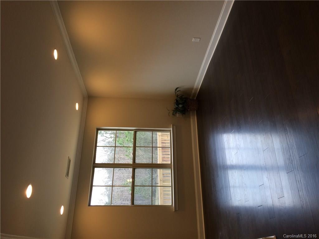 121 Helton Lane, Unit 47 Fort Mill, SC 29708 - Photo 15 of 20 a view of an empty room with wooden floor and a window