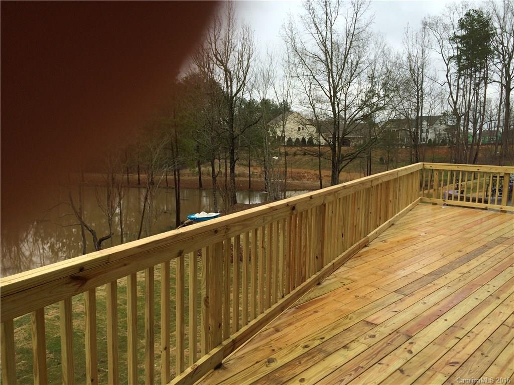 121 Helton Lane, Unit 47 Fort Mill, SC 29708 - Photo 16 of 20 a view of balcony with wooden floor and trees