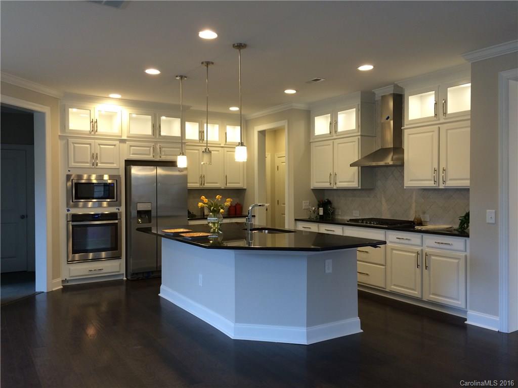 121 Helton Lane, Unit 47 Fort Mill, SC 29708 - Photo 4 of 20 a kitchen with stainless steel appliances granite countertop a sink a stove and a refrigerator