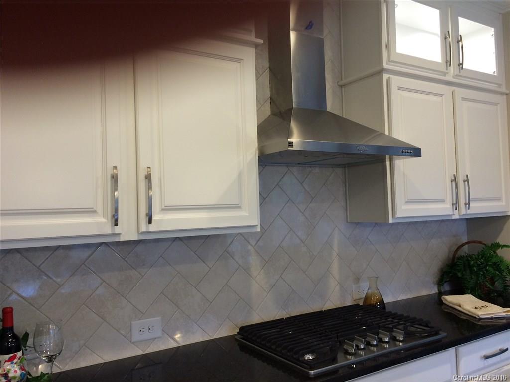 121 Helton Lane, Unit 47 Fort Mill, SC 29708 - Photo 10 of 20 a kitchen with granite countertop a sink and a stove