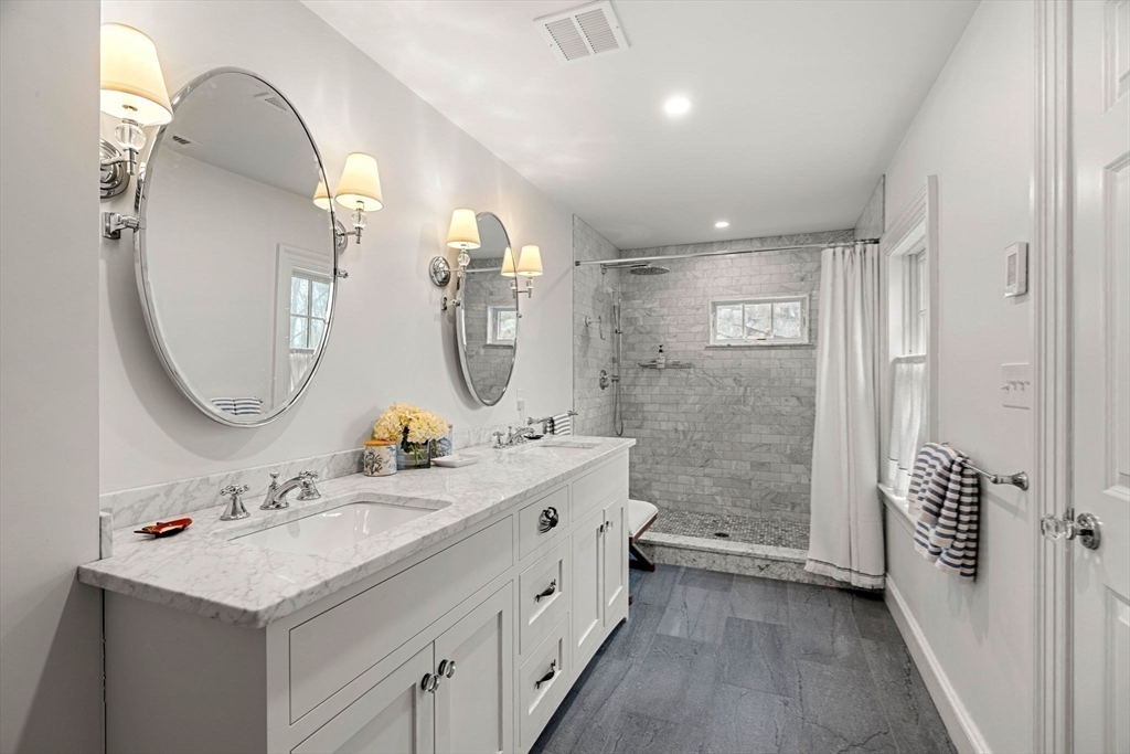 9 Windemere Park Manchester, MA 01944 - Photo 14 of 31 a bathroom with a double vanity sink mirror and shower