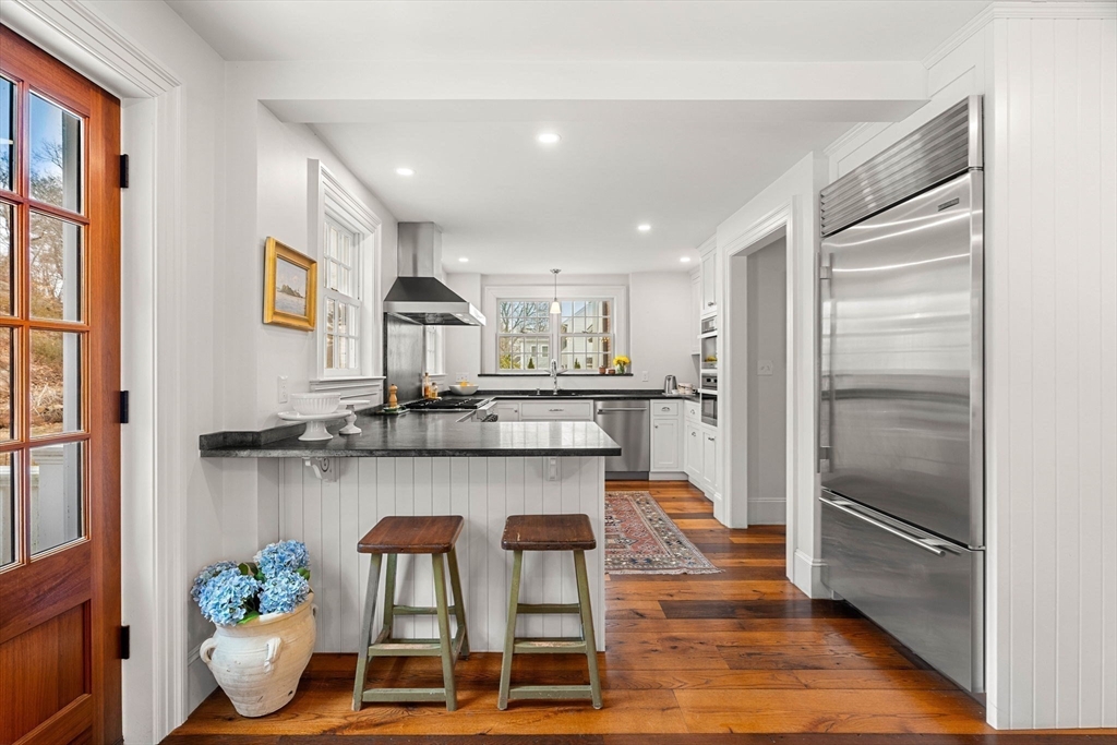 9 Windemere Park Manchester, MA 01944 - Photo 3 of 31 a kitchen with stainless steel appliances granite countertop a refrigerator and a stove