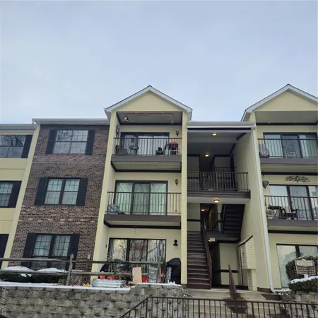 a front view of a residential apartment building with a yard