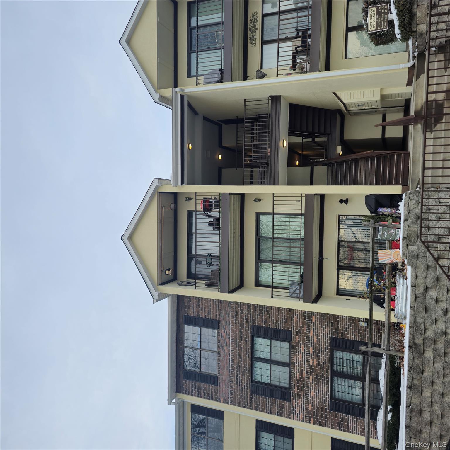 a front view of a residential apartment building with a yard