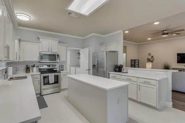a kitchen with a sink stove and refrigerator