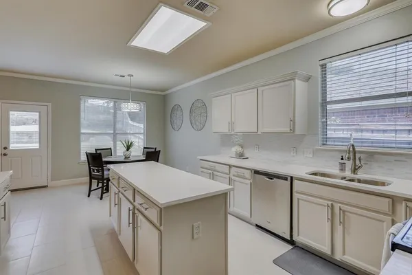 a kitchen that has a sink and a stove in it