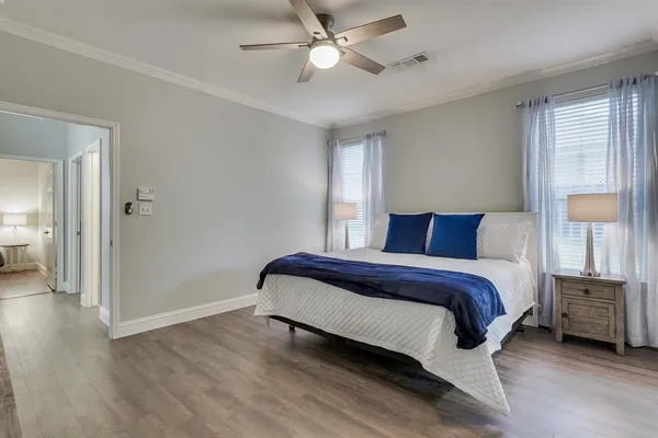 a bedroom with a bed and a chandelier