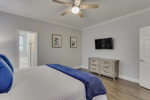 a bedroom with a bed and wooden floor