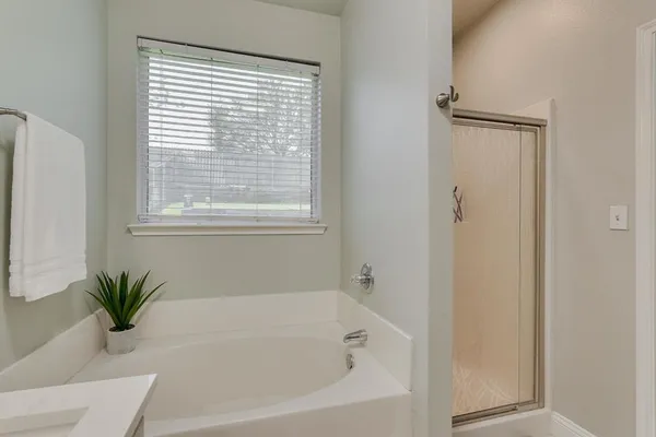 a white bath tub with a shower