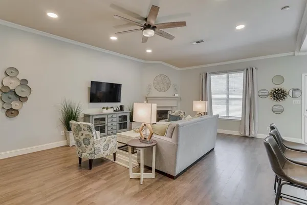 a living room with furniture a flat screen tv and a fireplace