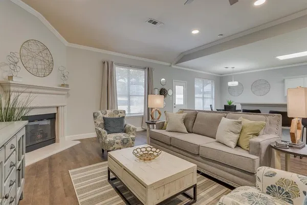 a living room with furniture a fireplace and a rug