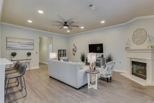 a living room with furniture a fireplace and a flat screen tv