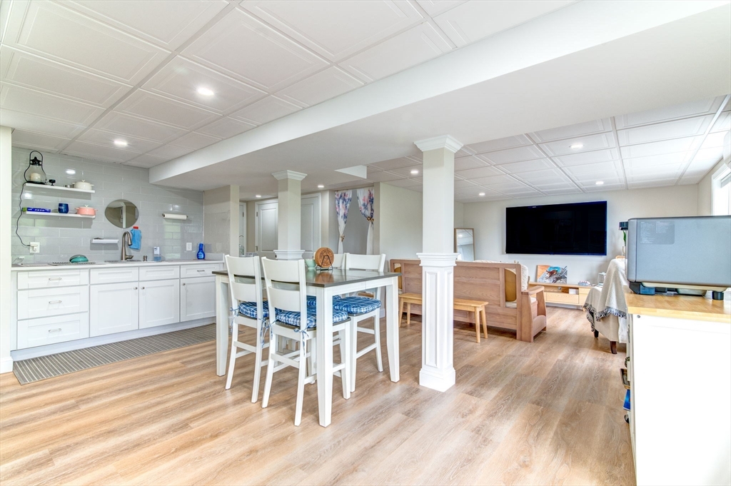 51 Tamarack Road Dracut, MA 01826 - Photo 28 of 39 a view of a dining room with furniture and wooden floor