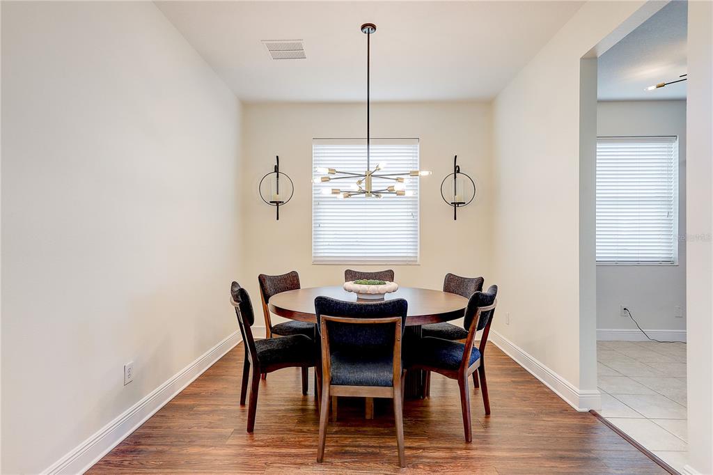 2410 Hawks Point Court Ruskin, FL 33570 - Photo 11 of 82 a dining room with furniture and wooden floor