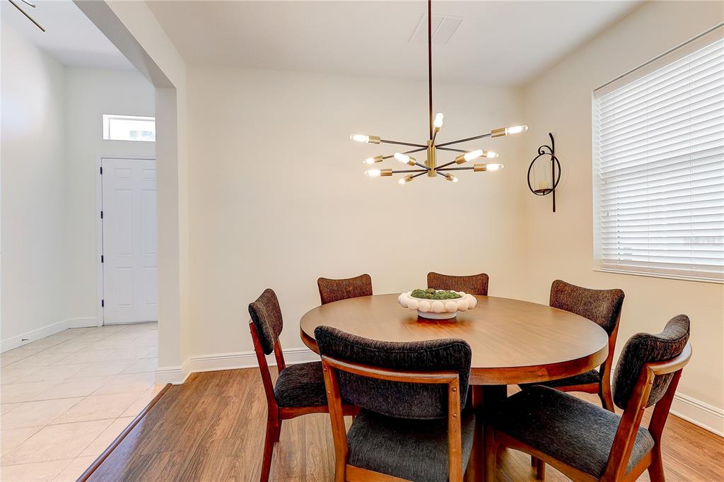 2410 Hawks Point Court Ruskin, FL 33570 - Photo 12 of 82 a view of a dining room with furniture and wooden floor