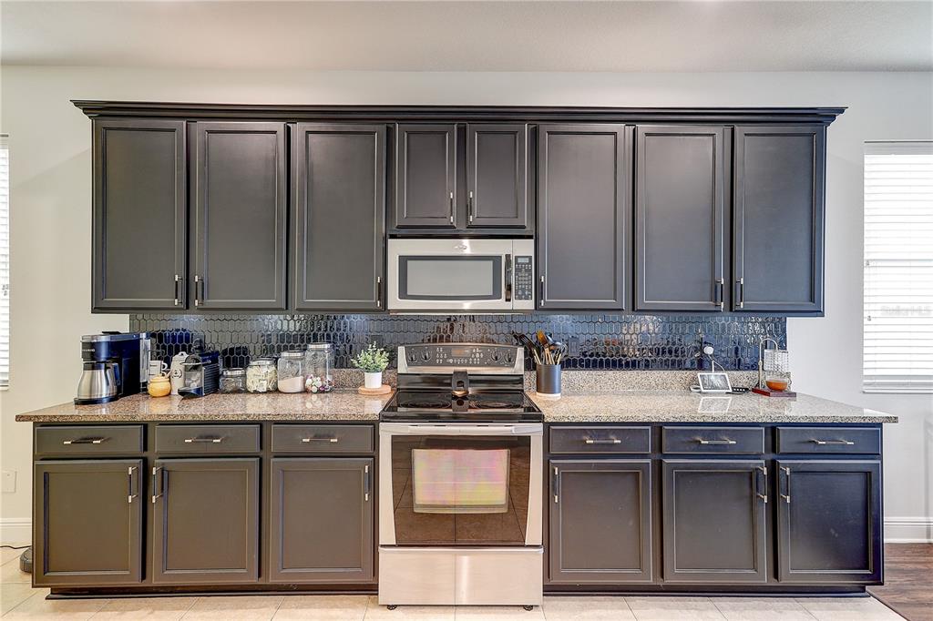 2410 Hawks Point Court Ruskin, FL 33570 - Photo 22 of 82 a kitchen with stainless steel appliances granite countertop a stove a sink and a microwave