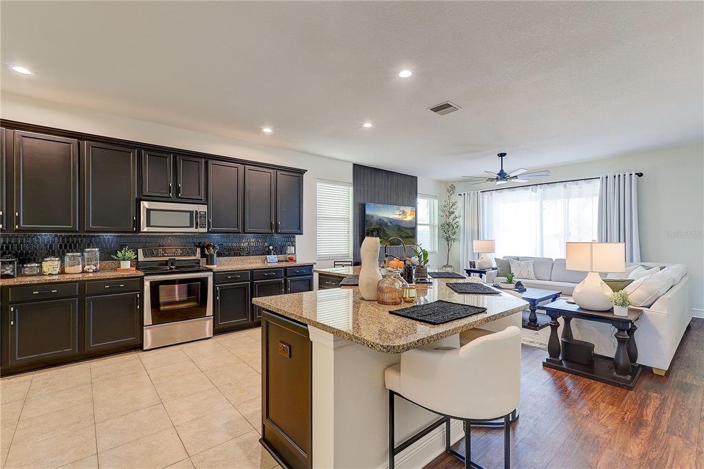 2410 Hawks Point Court Ruskin, FL 33570 - Photo 24 of 82 a kitchen with sink a microwave and cabinets