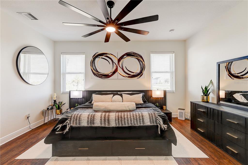 2410 Hawks Point Court Ruskin, FL 33570 - Photo 31 of 82 a bedroom with a large bed and a chandelier