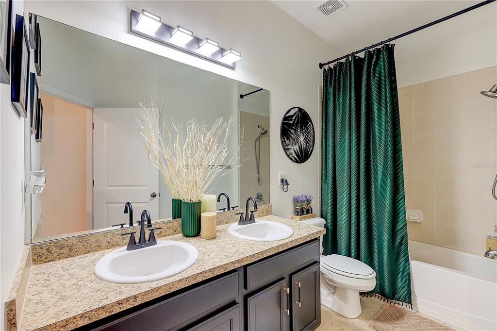 2410 Hawks Point Court Ruskin, FL 33570 - Photo 39 of 82 a bathroom with a granite countertop sink and a mirror