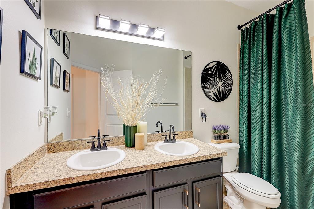 2410 Hawks Point Court Ruskin, FL 33570 - Photo 40 of 82 a bathroom with a granite countertop sink and a mirror