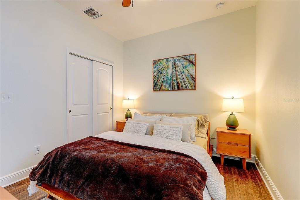 2410 Hawks Point Court Ruskin, FL 33570 - Photo 42 of 82 a bedroom with a bed and wooden floor