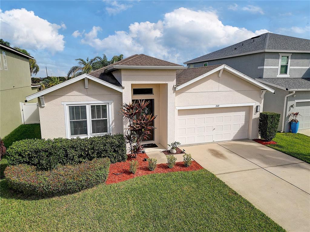 2410 Hawks Point Court Ruskin, FL 33570 - Photo 82 of 82 a front view of a house with a yard and garage