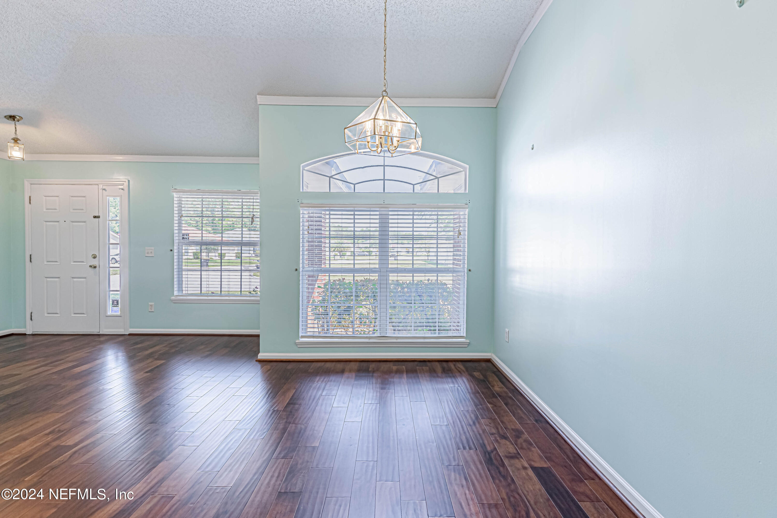 9380 Lockheed Lane Jacksonville, FL 32221 - Photo 11 of 40 a view of an empty room with wooden floor and a window