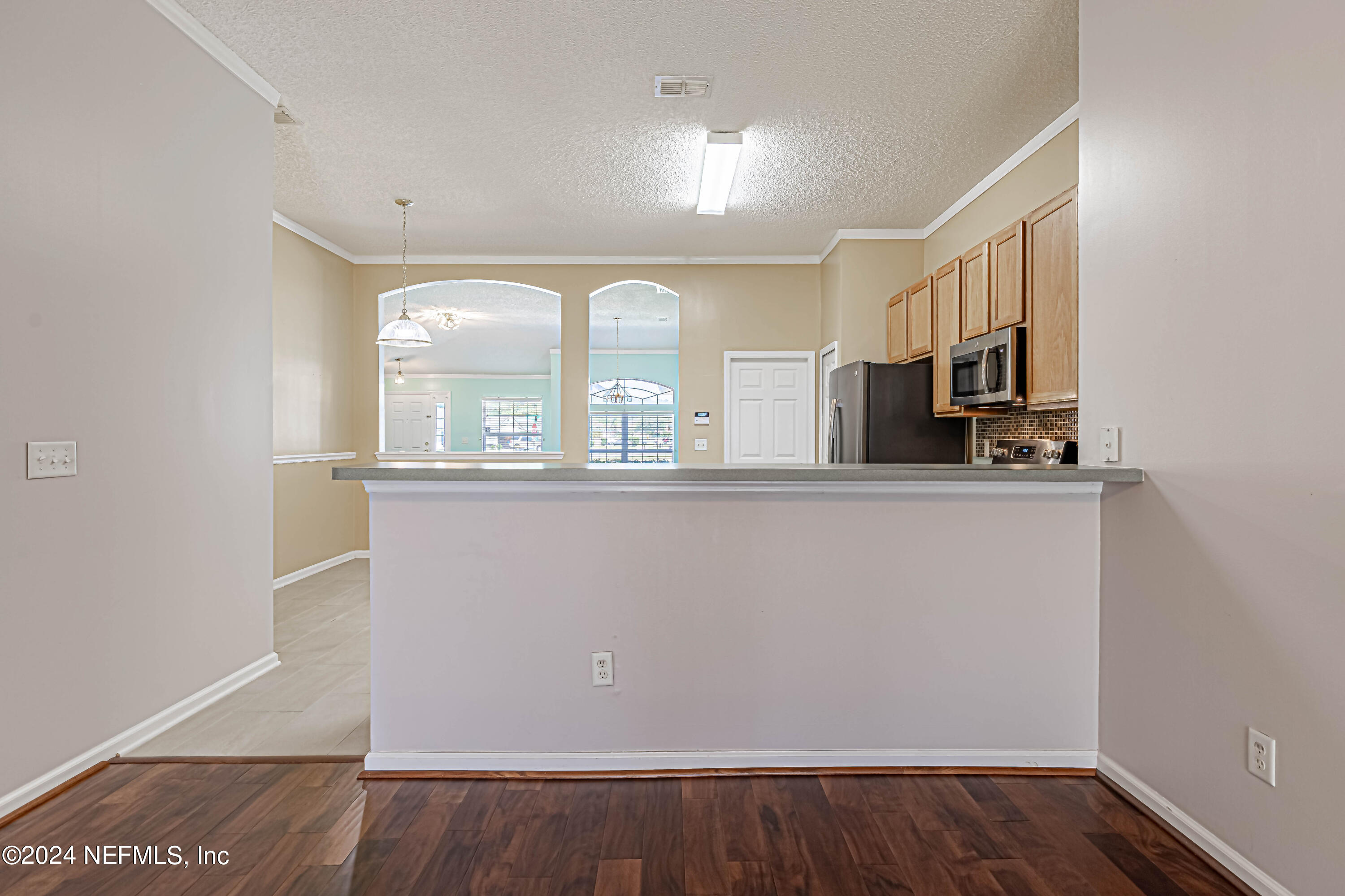 9380 Lockheed Lane Jacksonville, FL 32221 - Photo 17 of 40 a view of a kitchen with a sink and dishwasher a microwave oven