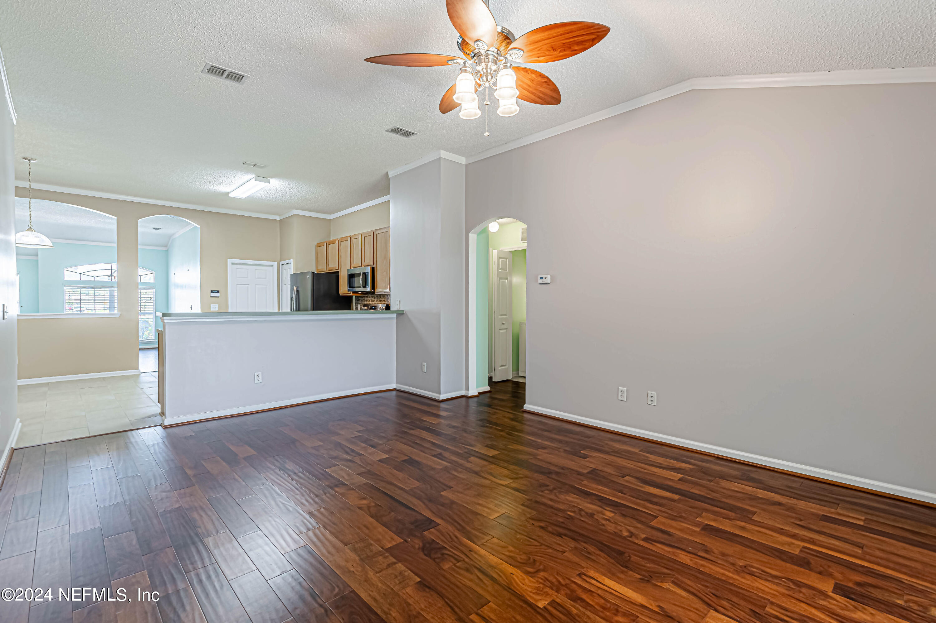 9380 Lockheed Lane Jacksonville, FL 32221 - Photo 19 of 40 a view of a kitchen with wooden floor and a ceiling fan