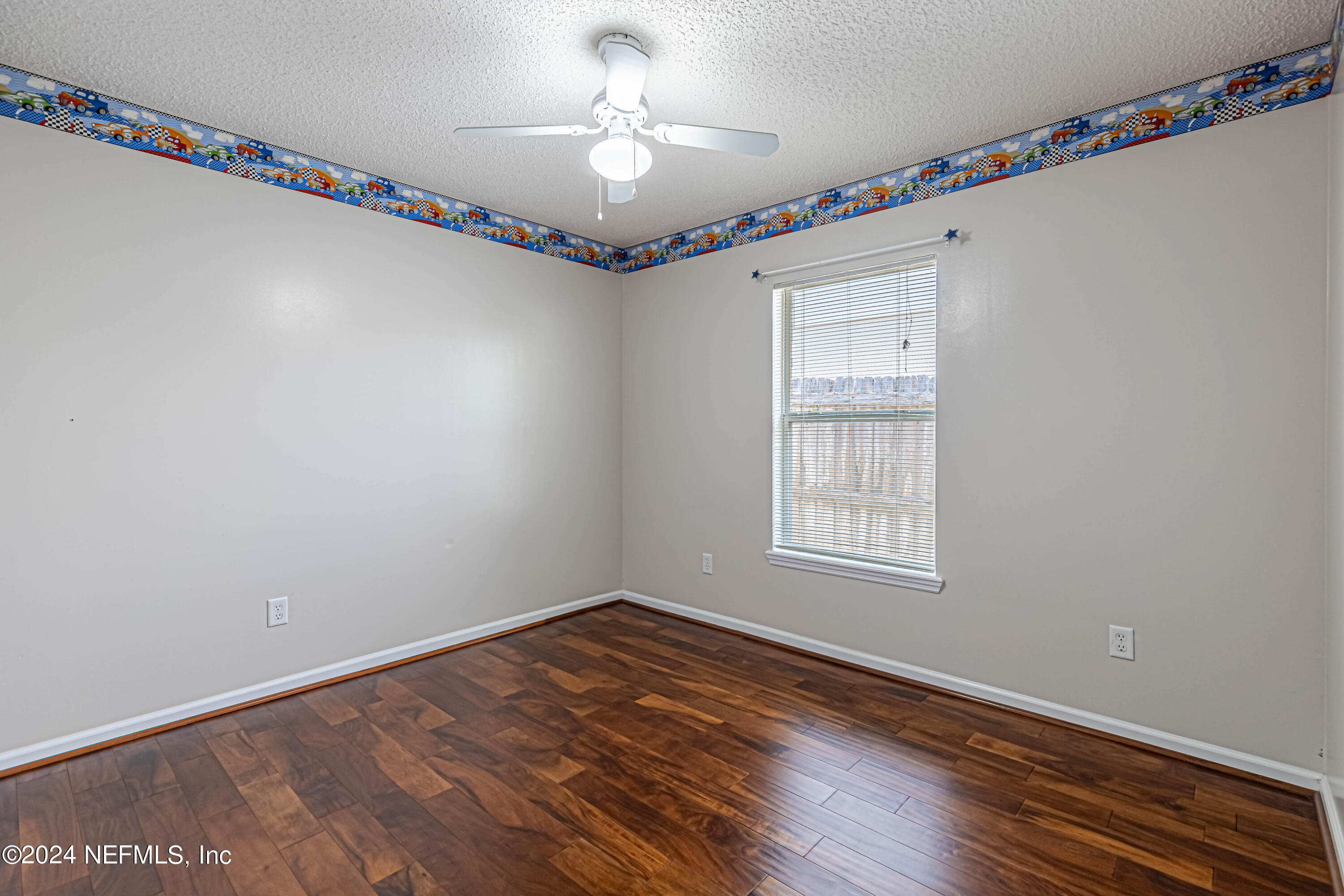9380 Lockheed Lane Jacksonville, FL 32221 - Photo 23 of 40 a view of an empty room with a window and wooden floor