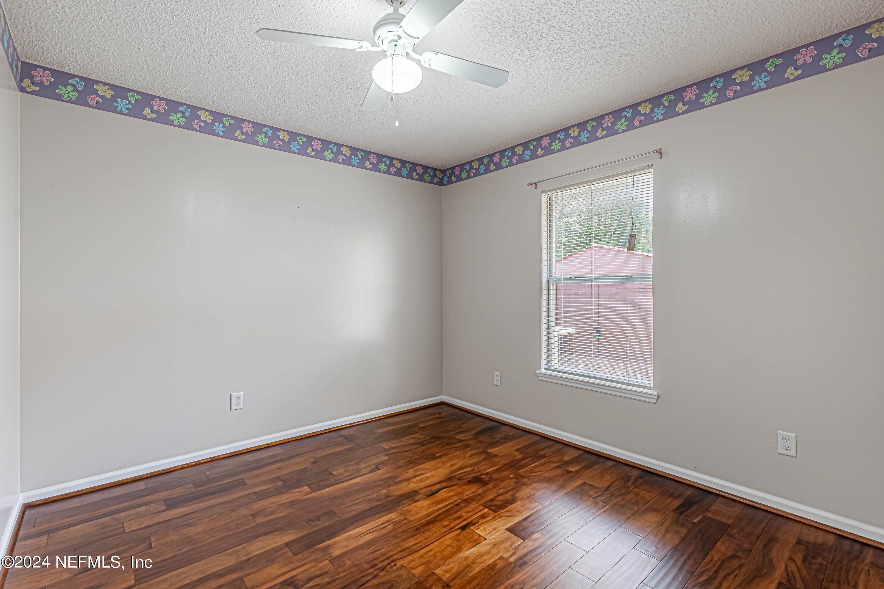 9380 Lockheed Lane Jacksonville, FL 32221 - Photo 28 of 40 a view of an empty room with wooden floor and a window