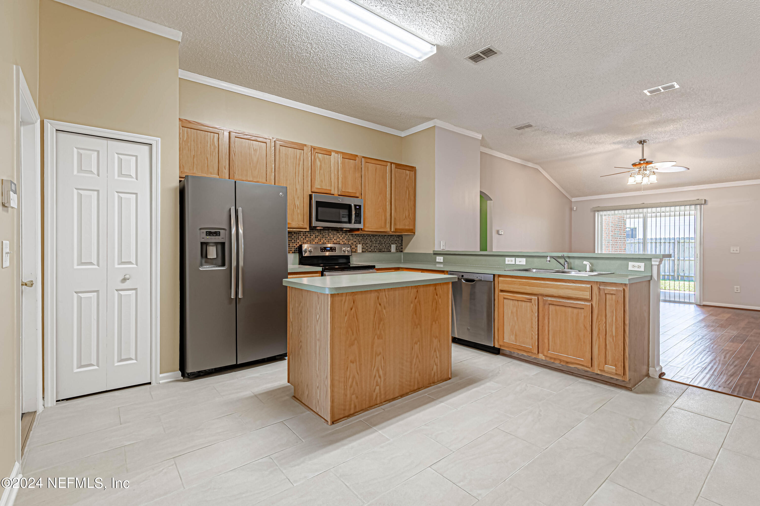 9380 Lockheed Lane Jacksonville, FL 32221 - Photo 3 of 40 a kitchen with stainless steel appliances granite countertop a refrigerator a stove top oven a sink and dishwasher