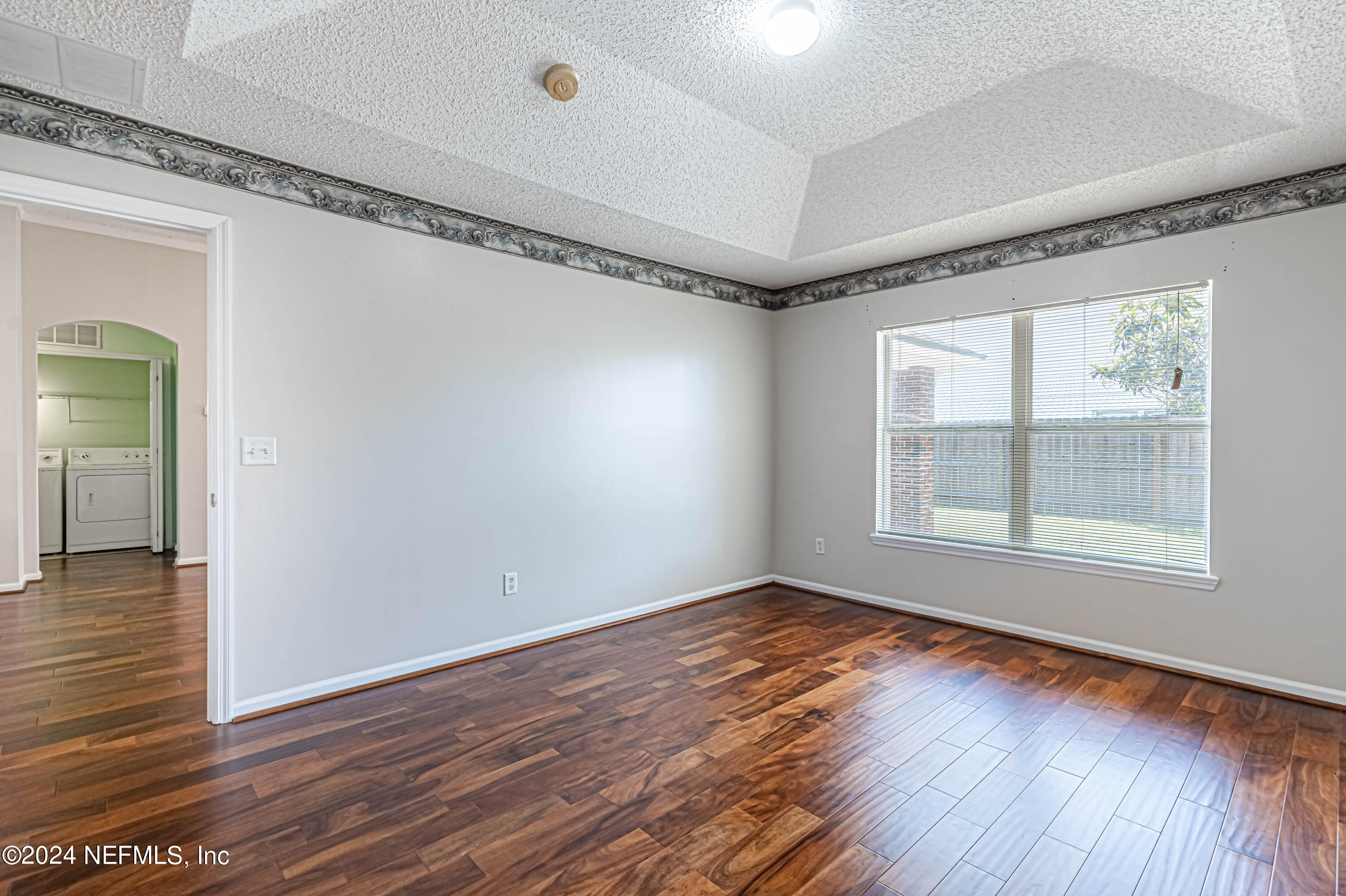 9380 Lockheed Lane Jacksonville, FL 32221 - Photo 33 of 40 a view of an empty room with wooden floor and a window