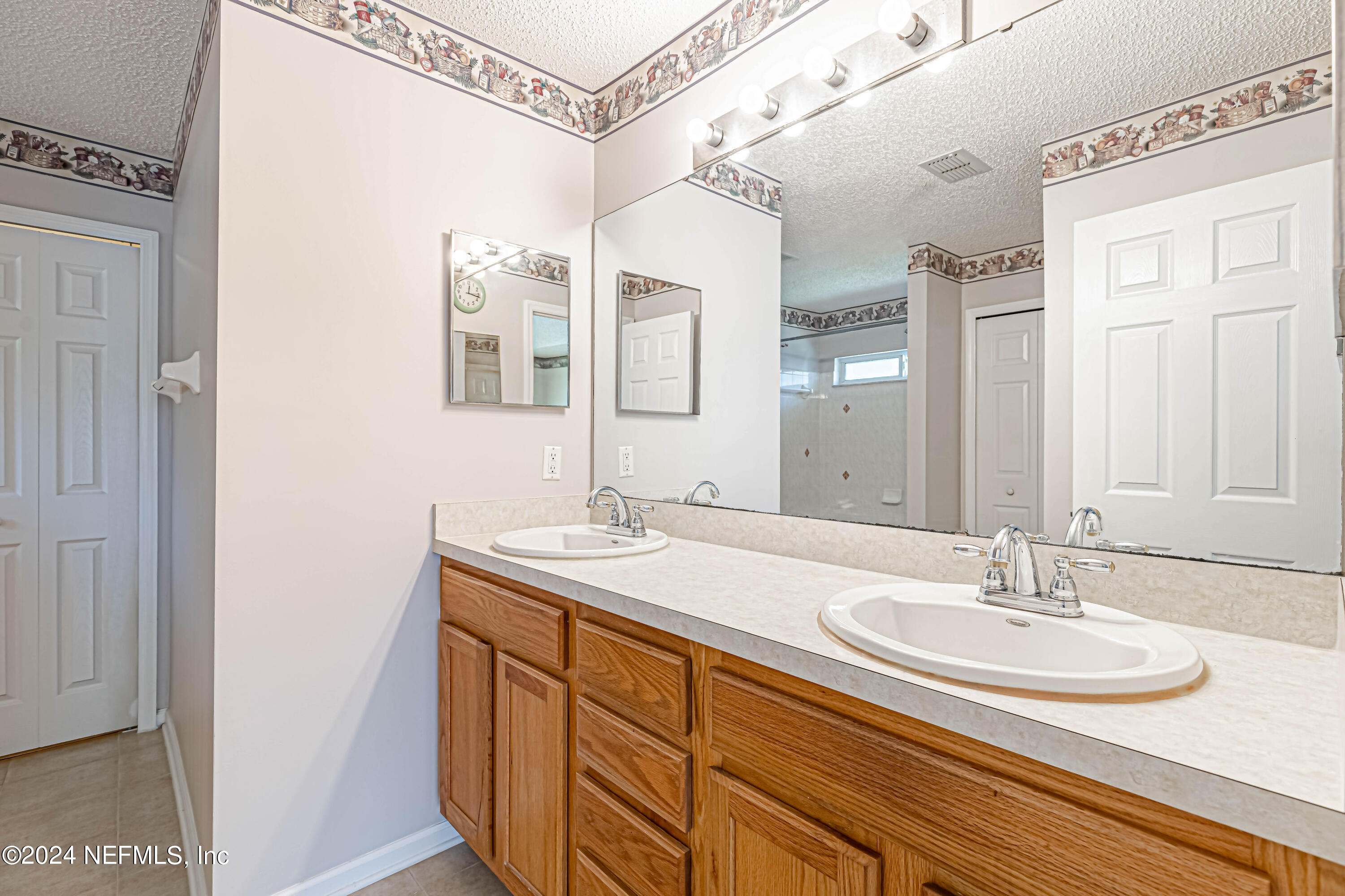 9380 Lockheed Lane Jacksonville, FL 32221 - Photo 34 of 40 a bathroom with a sink and a mirror