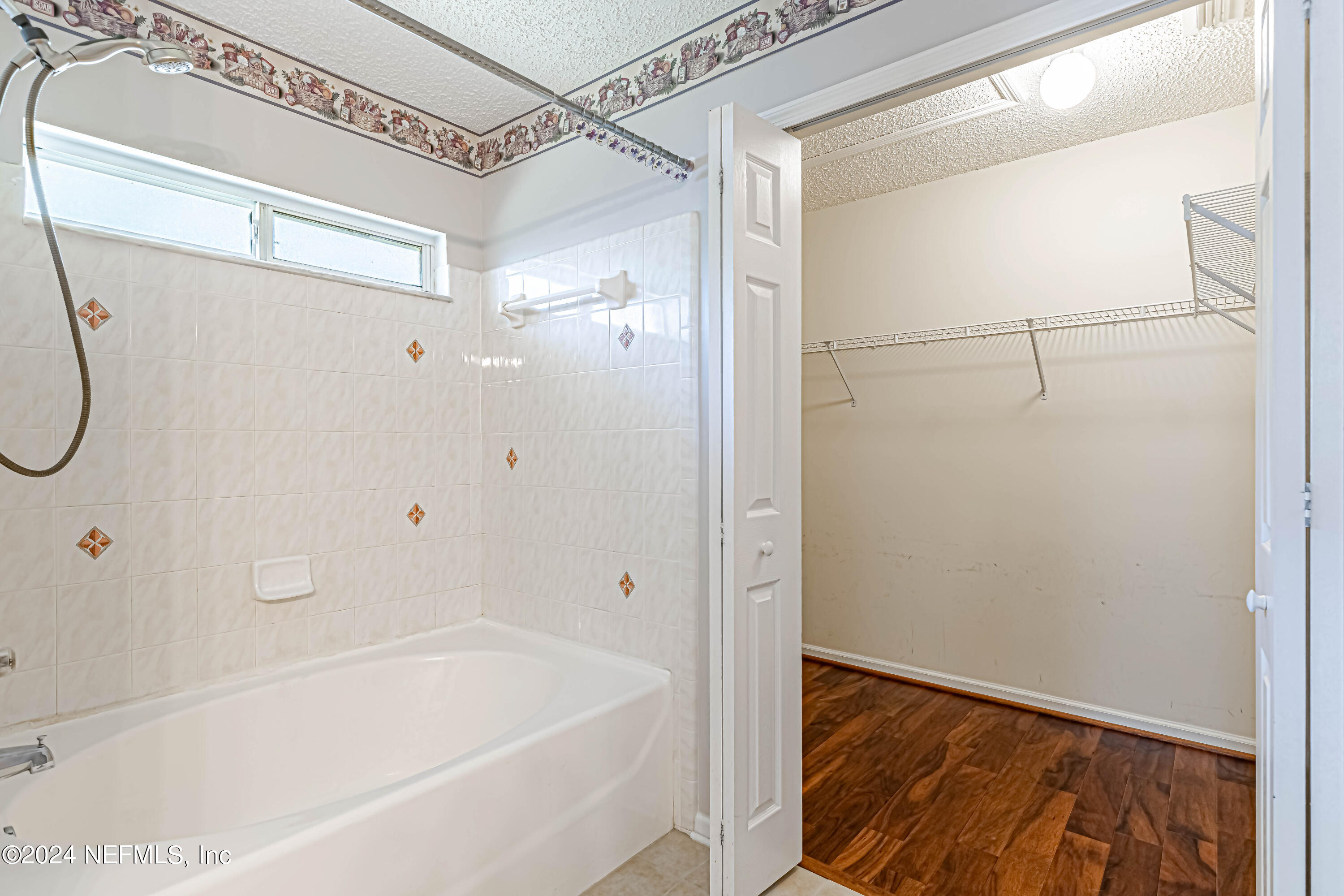 9380 Lockheed Lane Jacksonville, FL 32221 - Photo 35 of 40 a bathroom with a bathtub and a shower