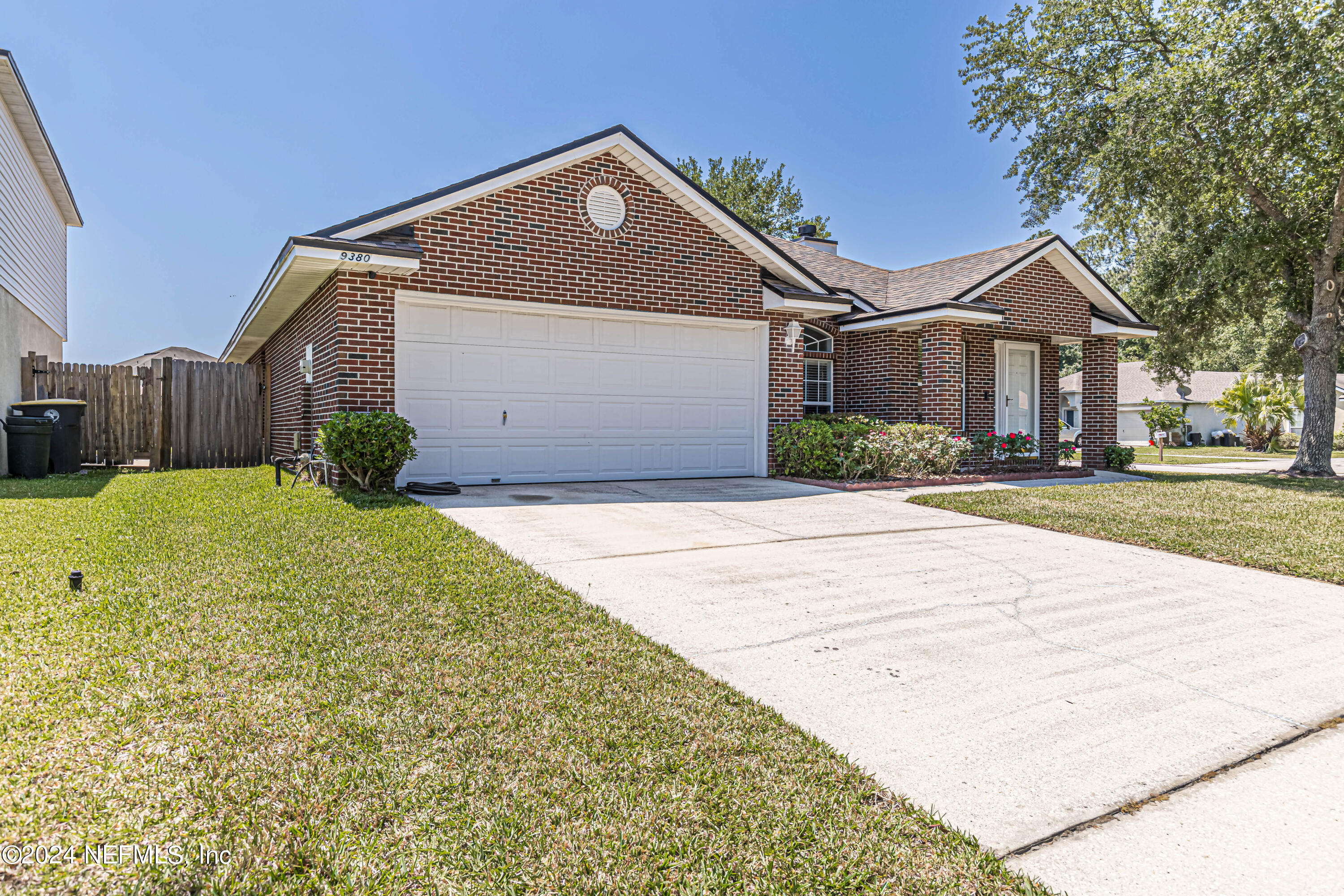 9380 Lockheed Lane Jacksonville, FL 32221 - Photo 5 of 40 a front view of a house with a yard and garage