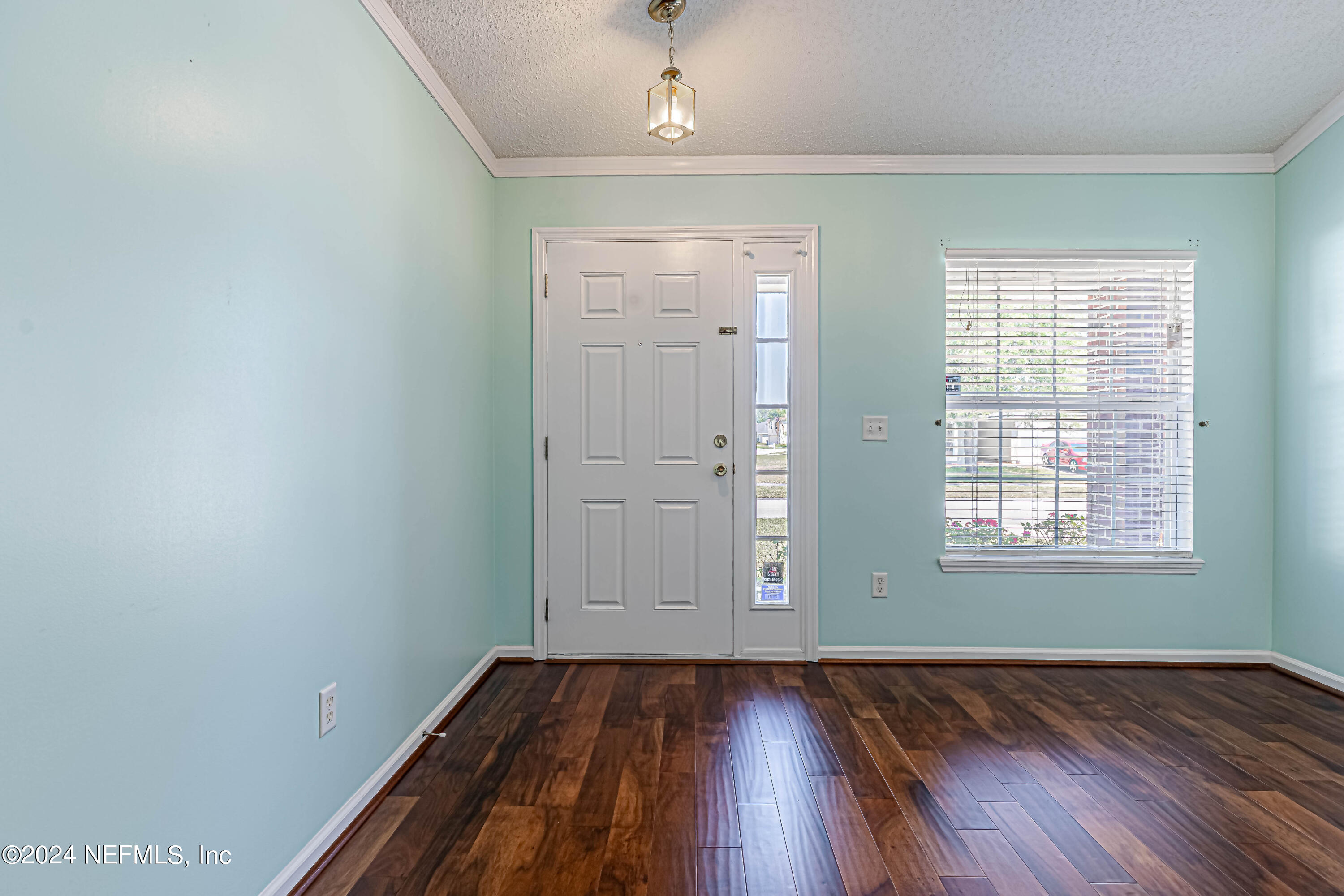 9380 Lockheed Lane Jacksonville, FL 32221 - Photo 8 of 40 an empty room with wooden floor cabinet and windows